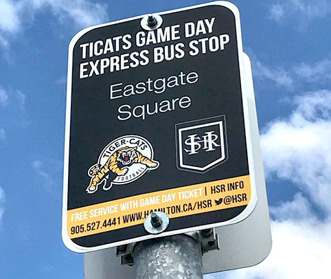Image of a sign post, text "Ticats Game Day Express Bus Stop"