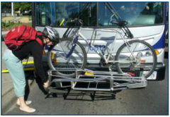 Person using lock on bike rack to secure bike to HSR bus