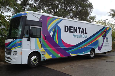 Sideview on the Dental Health Bus, parked in an open lot
