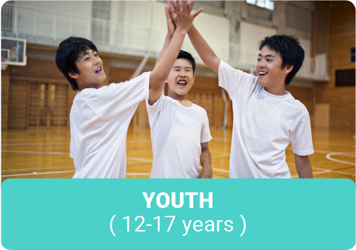 Group of smiling boys high-fiving on the basketball court