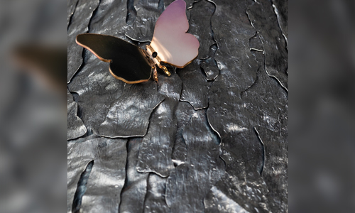 metallic butterfly on metallic bark