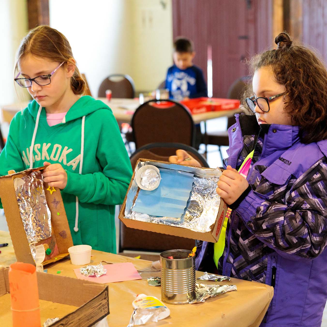 2 girls working on craft project