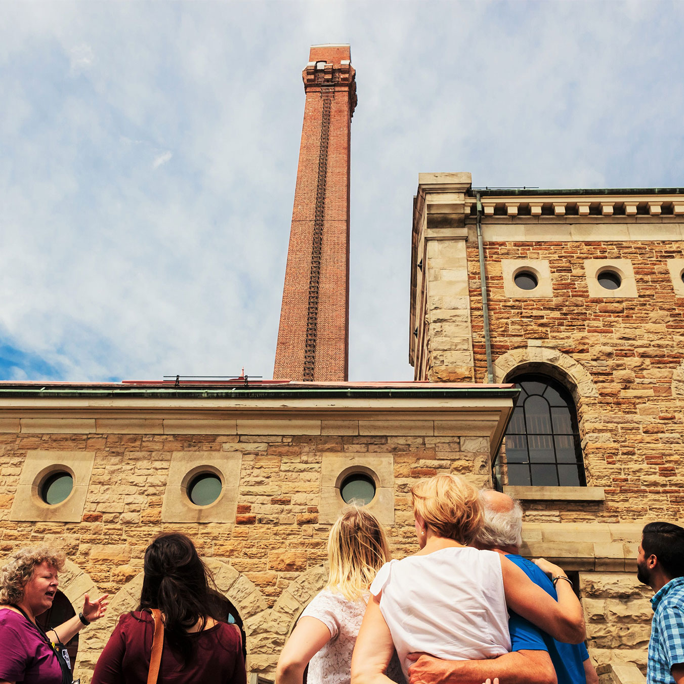 group of people looking up at Steam Museum tower during tout