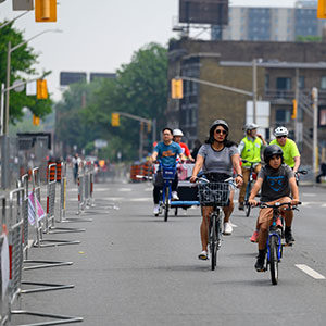 Group of people riding bicycles on closed street during Open Street Event