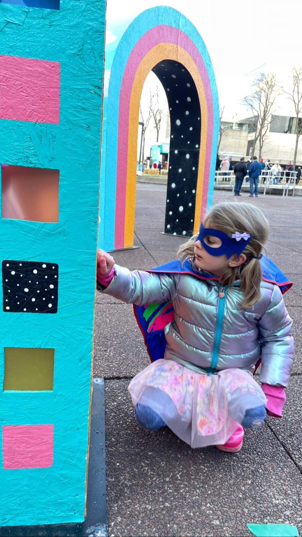 Hamilton Winterfest - child in a superhero costume and winter coat interacting with a winterfest art exhibit