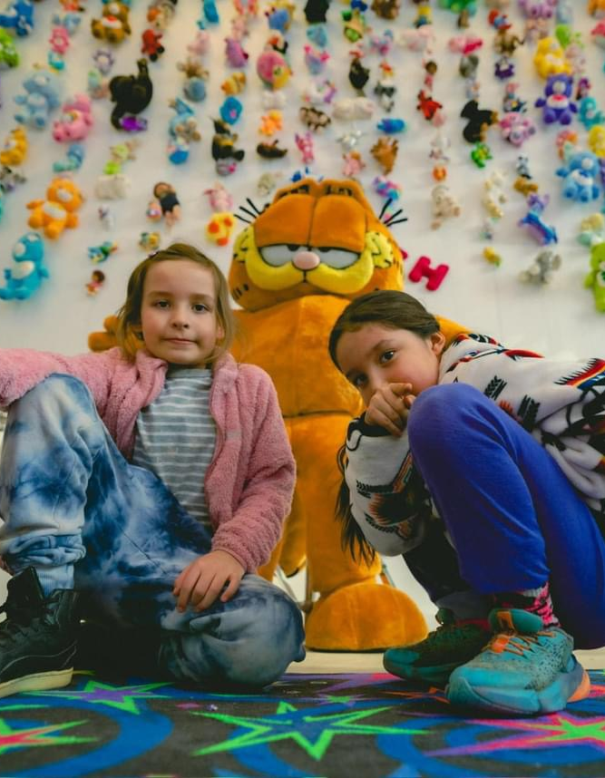 Hamilton Winterfest - two children pose with a Garfield the cat figurine as part of a Winter fest exhibit