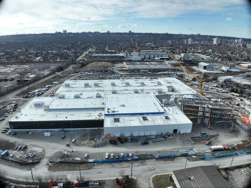 View looking south from Brant Street. The roof is complete, and the glass wall in the maintenance area is complete.