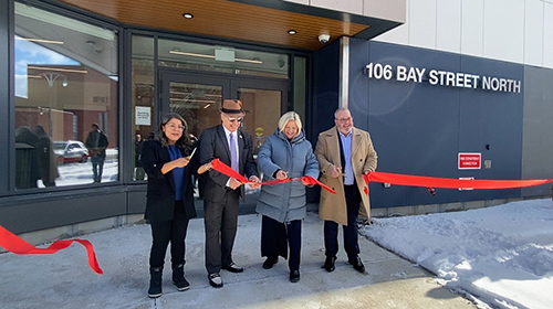 Ribbon cutting at 106 Bay St. N. L to R are President of the Board and Ward 3 Councillor Nrinder Nann, tenant Phillip Monson, Mayor Andrea Horwath, and CEO Adam Sweedland.