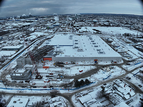 Photo taken February 20 looking east. The new parking structure is being assembled (located at bottom left of picture) and the steel administration building is being erected.