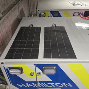 Two solar panels installed on the roof of an ambulance