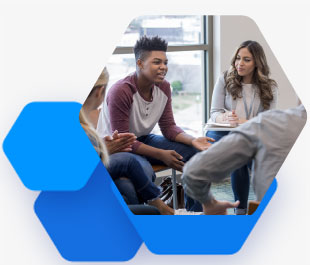 Teen boy talking to a group of other teens