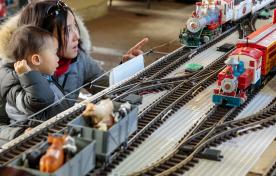 Mother and child looking at model trains