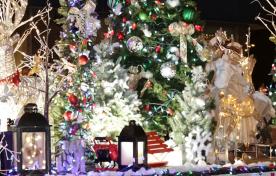 Holiday parade float, decorated Christmas trees, lanterns and reindeer