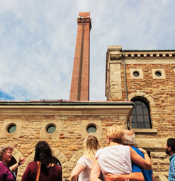 group of people looking up at Steam Museum tower during tout