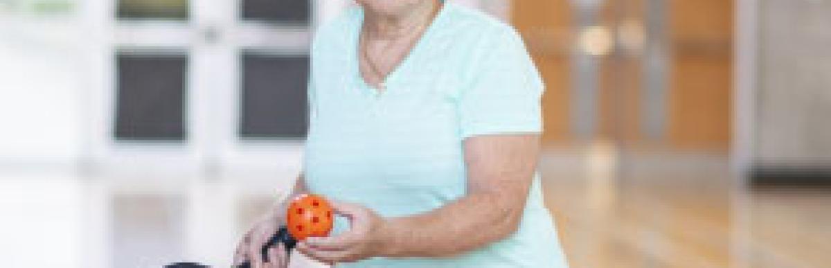 Older woman playing pickleball on an indoor court