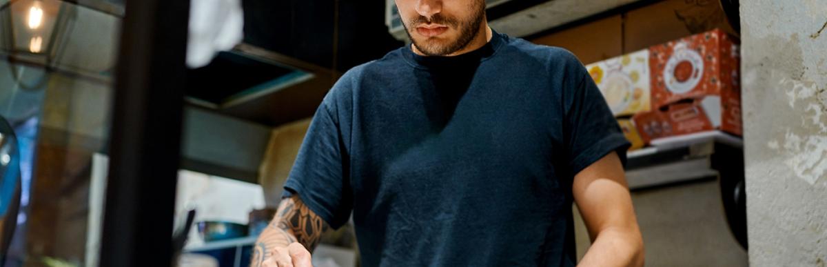 Chef plating a meal in a restaurant kitchen