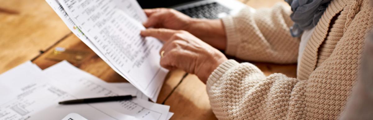 Cropped view of a senior woman receiving help with documents and finances