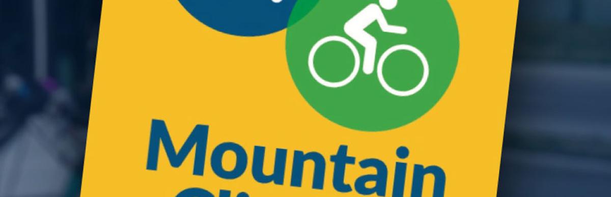 Yellow sign on a post post with a bus and bicycle icon with text "Mountain Climber' underneath