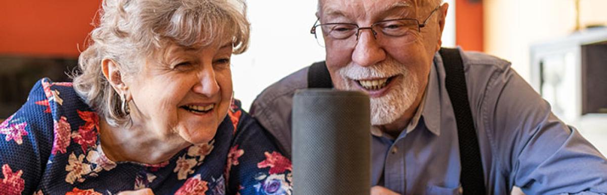 Photo of older couple taking to smart device