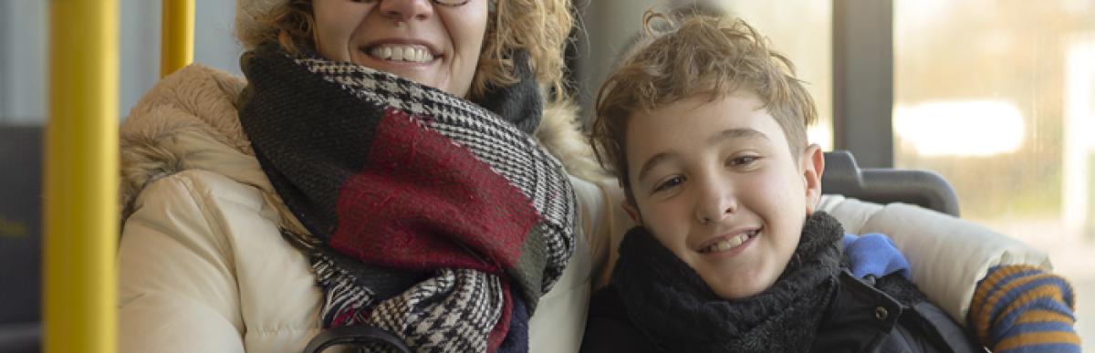 woman and child sitting on a bus dressed for winter