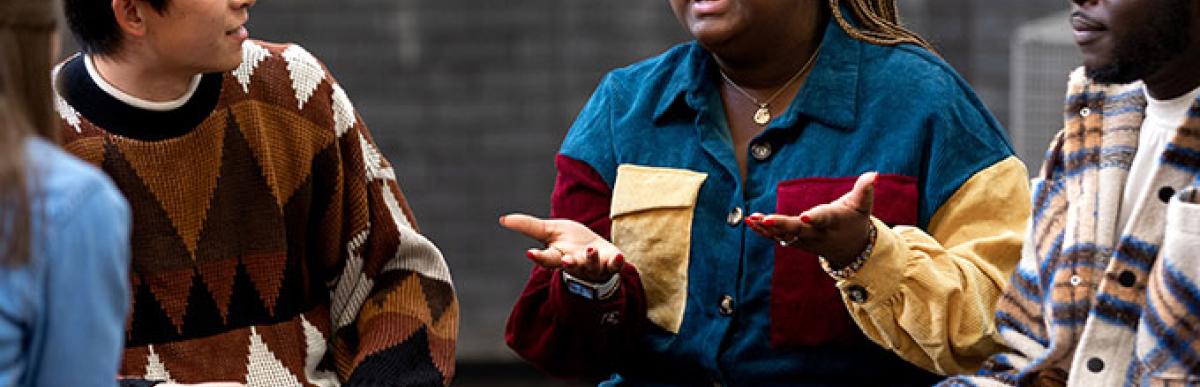 Group of adults sitting in a circle and talking to each other
