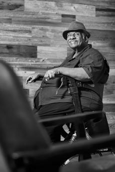 black and white image of man sitting in a chair