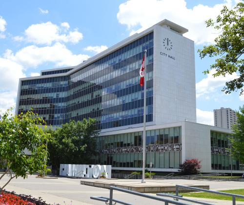 Exterior shot of Hamilton City Hall in the sunshine with blue sky