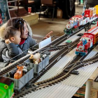 Mother and child looking at model trains