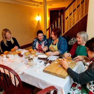 people around a table prepping food for cooking
